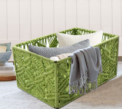 A green macrame basket that can hold a few pillows and rugs